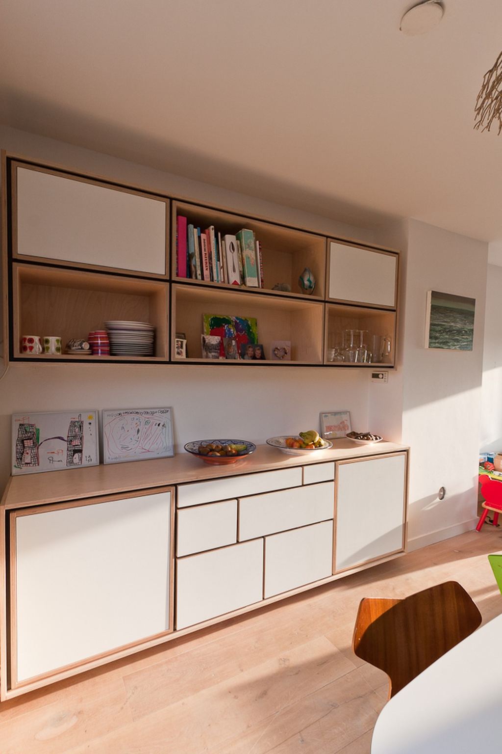Wandkast en buffetkast van berken multiplex met witte deuren en open vakken.